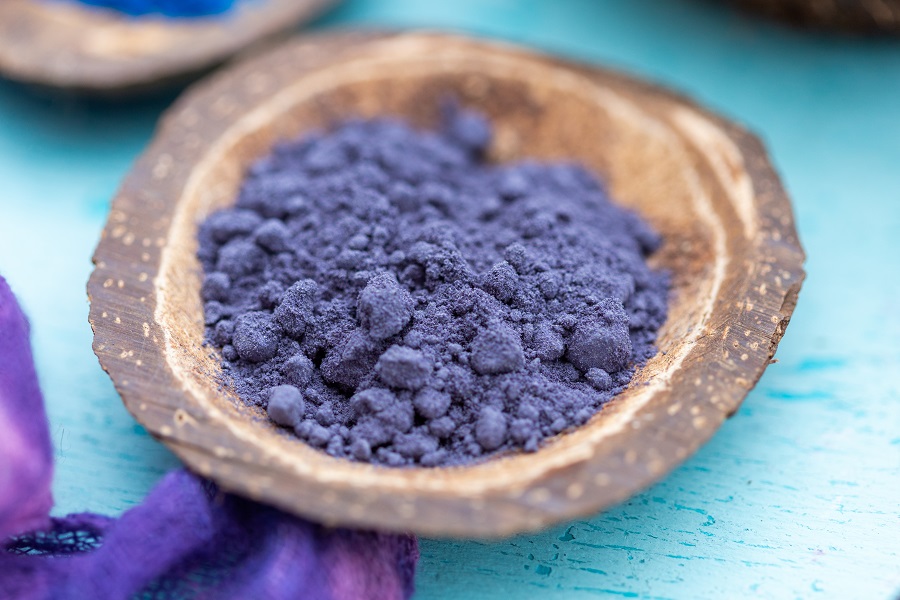 closeup shot purple food coloring powder small coconut plate