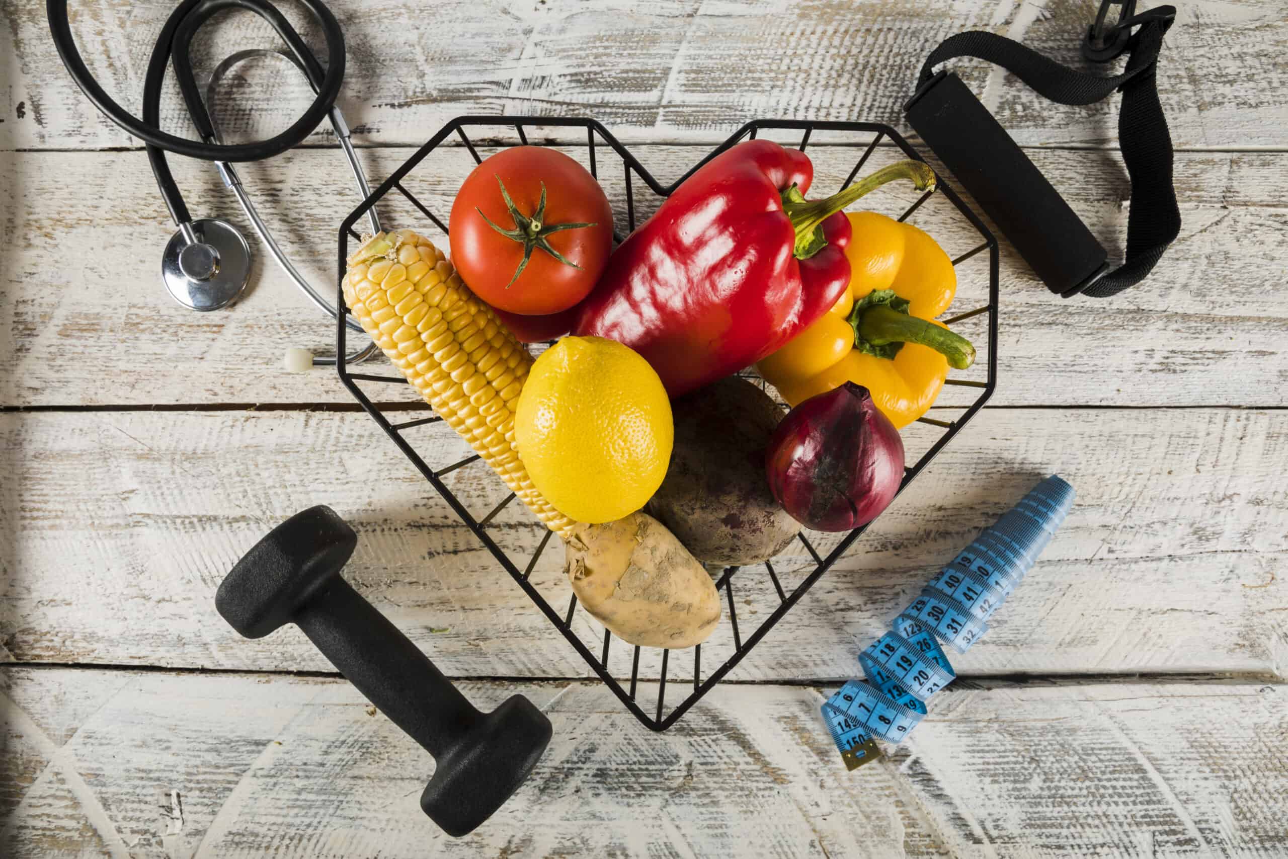 fresh vegetables surrounded by fitness equipments stethoscope measuring tape scaled 1